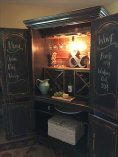 a wine cabinet with chalkboard writing on it