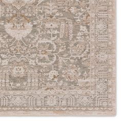 a beige and brown rug with an intricate design