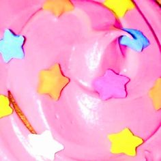 a pink frosted cake with stars on it