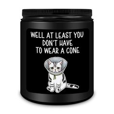 a black canister with a white cat on it that says, well at least you don't have to wear a cone