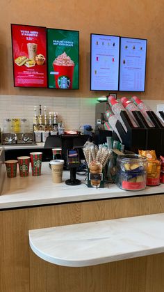 a counter in a fast food restaurant with menus on the wall and coffee machines