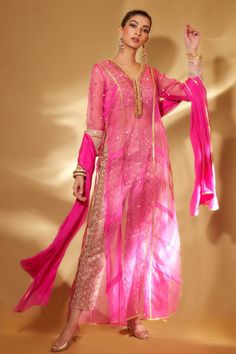 Pink sheer a-line kurta with gold cord, beads, mirror embroidery. Paired with embellished pant, crop top and dupatta.
Components: 4
Pattern: Embroidered
Type Of Work: Floral
Neckline: V neck
Sleeve Type: Full
Fabric: Organza
Color: Pink
Other Details: 
Side slits
Sheer
Cutwork lace detailing
Occasion: Puja - Aza Fashions Organza Suits Indian, Organza Kurta, Kurta With Palazzo, Desi Dress, Organza Suits, Kurta Pant Set, A Line Kurta, Traditional Indian Outfits