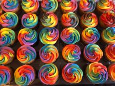 cupcakes with multi colored frosting in a box