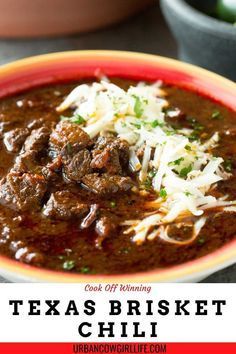 a bowl filled with chili beef and cheese