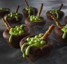 chocolate cupcakes decorated with green icing and sprinkles on sticks