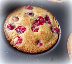 a close up of a cake in a pan with cherries on the top and bottom