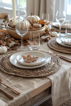 the table is set with white plates and silverware