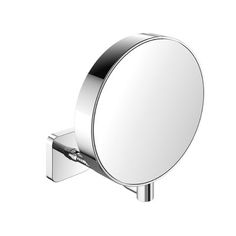 a round mirror mounted on the side of a metal wall mount faucet with an angled arm