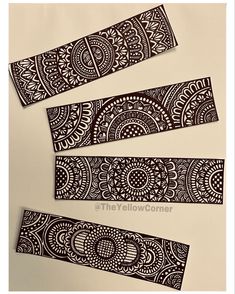 three pieces of black and white paper with designs on them