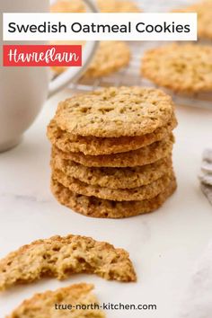 several oatmeal cookies stacked on top of each other next to a cup of coffee