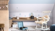 a child's room with rocking chair, dresser and toy chest