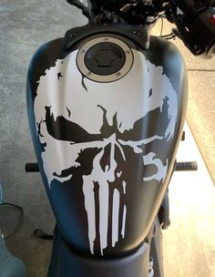 the front end of a motorcycle with a skull painted on it