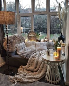 a living room filled with lots of furniture next to a large window covered in fur