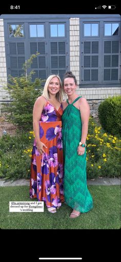 two women standing next to each other in dresses