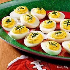 deviled eggs are arranged on a green platter