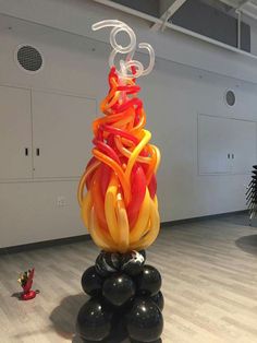 a sculpture made out of blown glass sitting on top of a hard wood floor