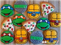 decorated cookies are arranged in the shape of teenage mutant pizzas and ninja turtle heads