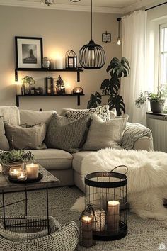 a living room filled with lots of furniture and candles on top of it's coffee table