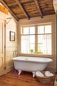 a white bath tub sitting next to a window