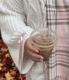 a woman holding a cup of coffee in her hands