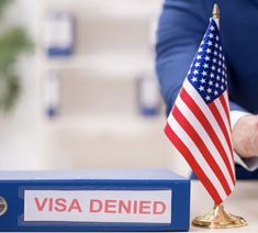 an american flag is placed on top of a binder next to a visa card holder