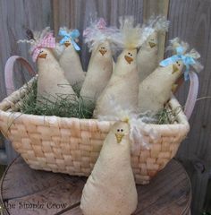 several stuffed chickens in a basket on a table