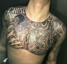 a man's chest with tattoos on it, and the word trust written in black ink