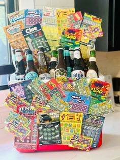 a red basket filled with lots of different types of sodas and candy bar wrappers