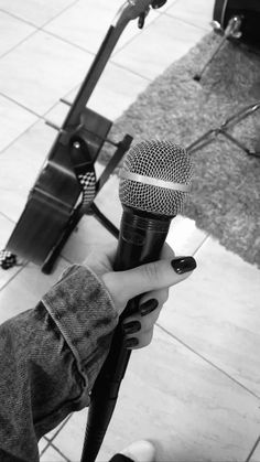 a person holding a microphone in their hand