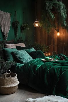 a bed with green sheets and pillows in a room filled with plants, candles and lights