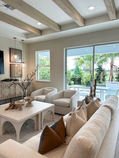 a living room filled with furniture and a flat screen tv mounted to the wall next to a fire place