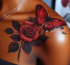 a woman's back with a butterfly and rose tattoo on it