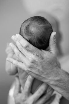 a person holding a baby up to their face