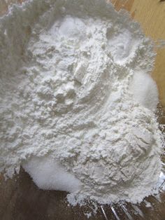 a pile of white powder sitting on top of a wooden table