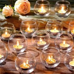 there are many candles in the glass bowls