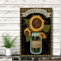 a wooden sign with sunflowers in a mason jar and welcome text on it