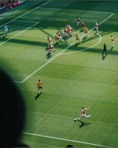 a group of people playing soccer on a field