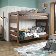 a bunk bed sitting on top of a hard wood floor next to a bedroom window