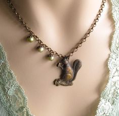 Step into a charming woodland world with our Vintage Style Squirrel Necklace.  This delightful piece captures the timeless appeal of nature and nostalgia.  Crafted with exquisite attention to detail, the squirrel necklace is a unique addition to your jewelry collection.   This necklace features a unique squirrel pendant with cute little acorn pearls one one side.  If you don't like the asymmetrical look, please let me know and I can add additional pearls to each side.   Want to customize this ne Squirrel Jewelry, Squirrel Necklace, Acorn Jewelry, Woodland Jewelry, Acorn Necklace, A Squirrel, Mom Jewelry, Aunt Gifts, Fall Jewelry