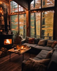 a living room filled with furniture and a fire place in front of a window covered in lights