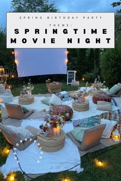 an outdoor movie party with chairs and pillows on the grass, surrounded by candles and lights