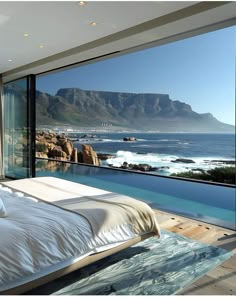 a bedroom with a view of the ocean and mountains