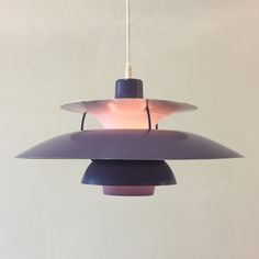 a blue and purple lamp hanging from a ceiling