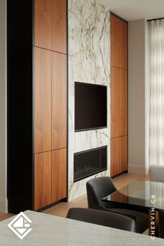 Modern and luxurious condo living room wall with a porcelain fireplace wall and walnut wall unit storage. Porcelain Fireplace Wall, Accent Wall Fireplace, Chic Coffee Bar, Slab Doors, Luxurious Living Room, Walnut Wall, Wall Fireplace