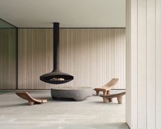 the interior of a modern house with wood and stone furniture, including a large fireplace