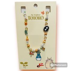 a necklace with charms on it in a box