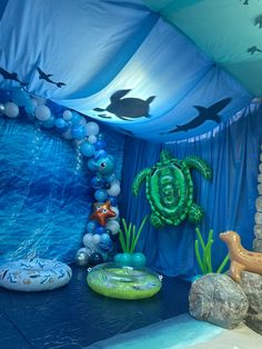 an underseam themed birthday party with balloons, decorations and sea animals on the walls