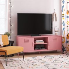 a living room with a pink entertainment center and yellow chair in front of the flat screen tv