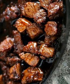 some meat is cooking in a pan on the stove top and it's ready to be cooked