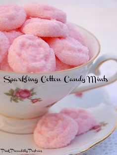 pink powdered donuts in a teacup on a saucer with the words sparkling cotton candy muffs